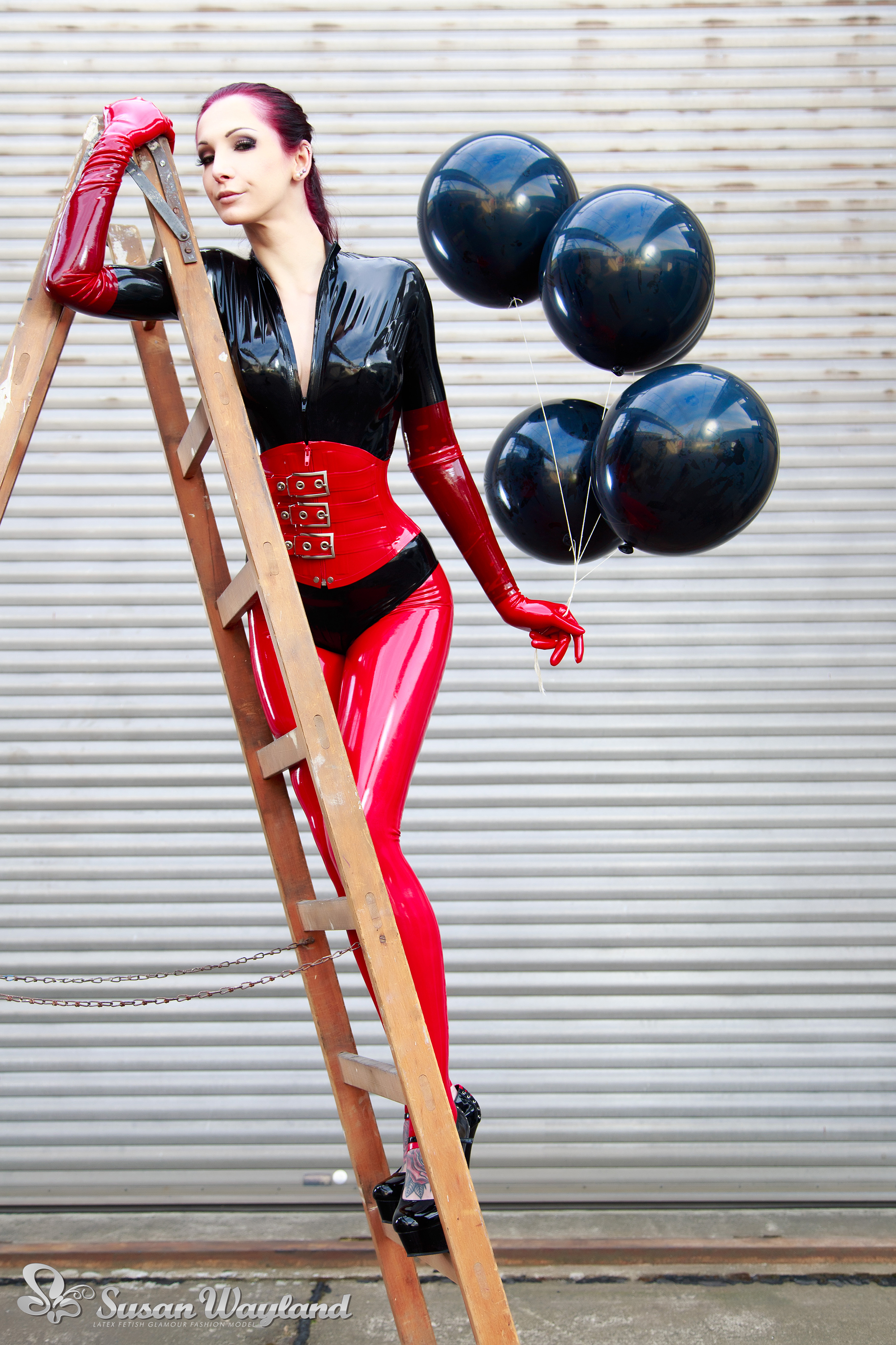 balloon black_hair breasts catsuit corset female gloves high_heels ladder large_breasts latex long_hair shoes solo susan_wayland watermark