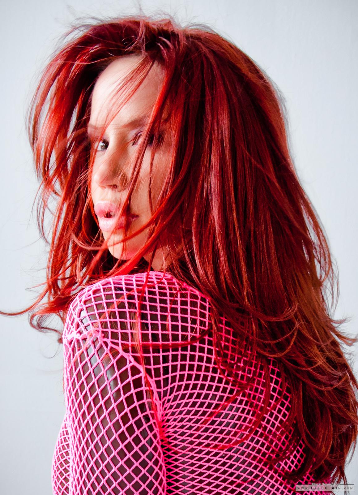 belt bianca_beauchamp breasts catsuit female fishnets high_heels large_breasts long_hair red_hair shoes simple_background solo watermark