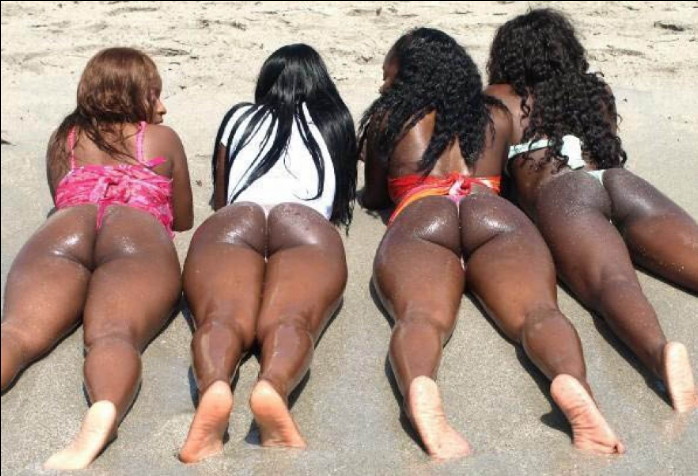 ass backside beach bikini black_hair brown_hair dark_skin long_hair lying multiple_girls on_stomach outside sandy swimsuit thong wet