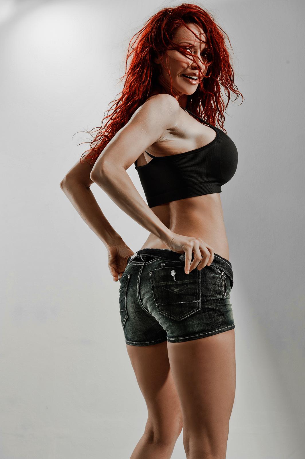 ass bianca_beauchamp breasts female large_breasts long_hair looking_back red_hair simple_background solo watermark