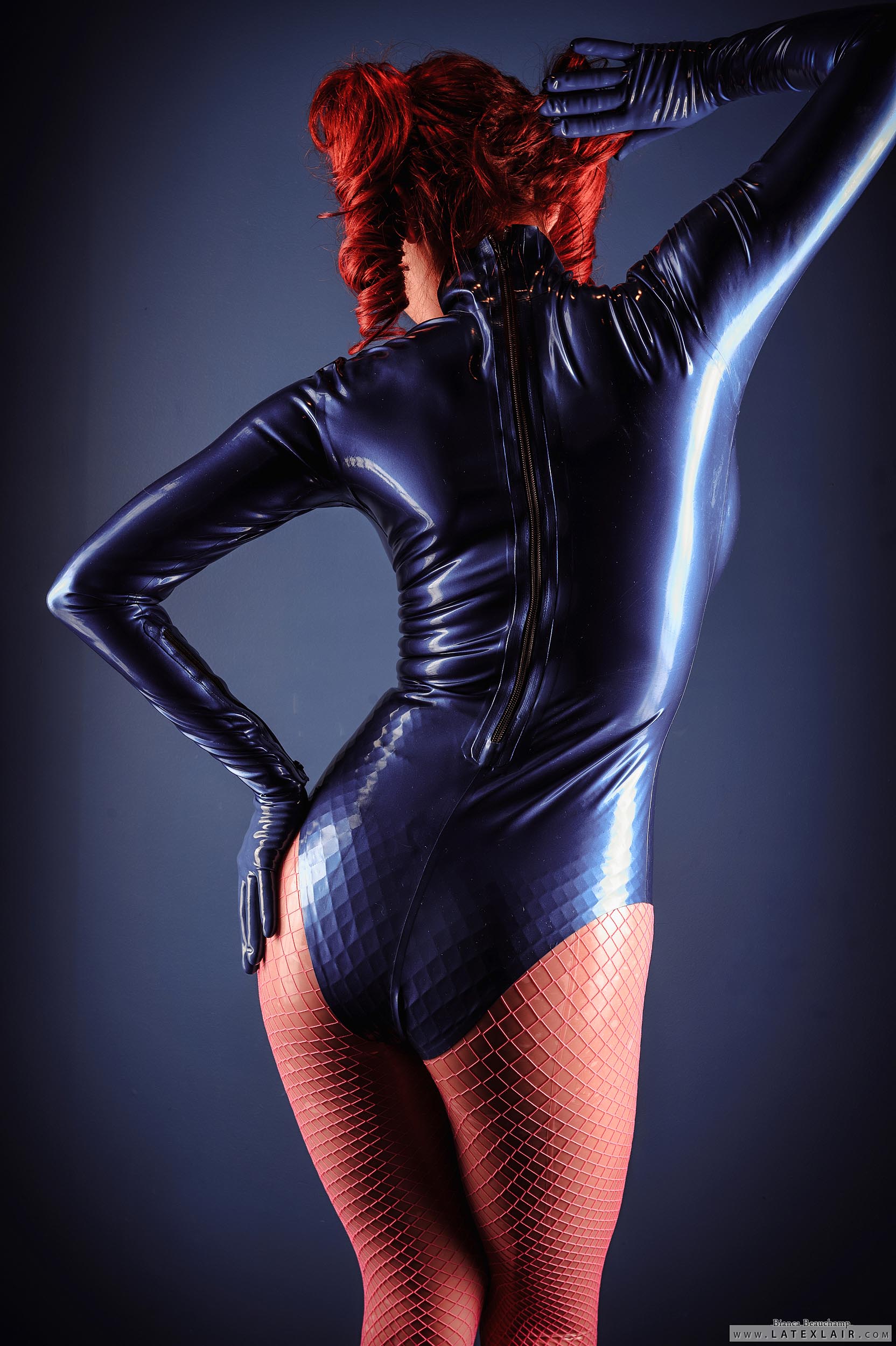ass bianca_beauchamp breasts female fishnets gloves high_heels large_breasts latex long_hair looking_back red_hair shoes solo watermark