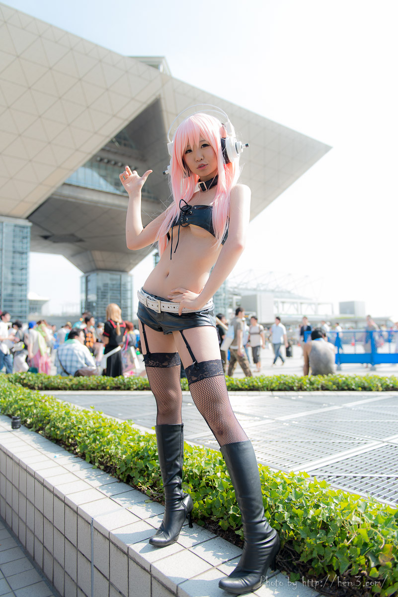 1girl asian breasts cosplay long_hair outside pink_hair standing super_sonico