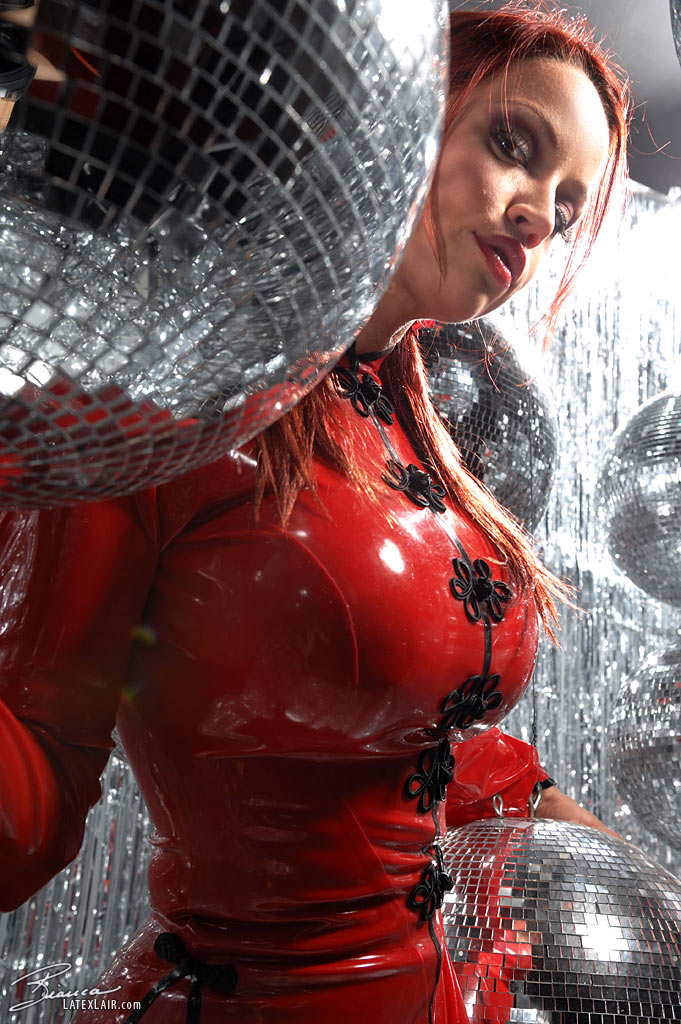 bianca_beauchamp breasts catsuit disco_ball female large_breasts latex long_hair pigtails red_hair solo