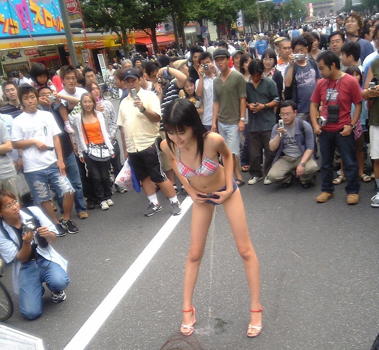 1girl asian exhibitionism female_focus filming outdoors pee peeing public solo_female standing swimsuit urine
