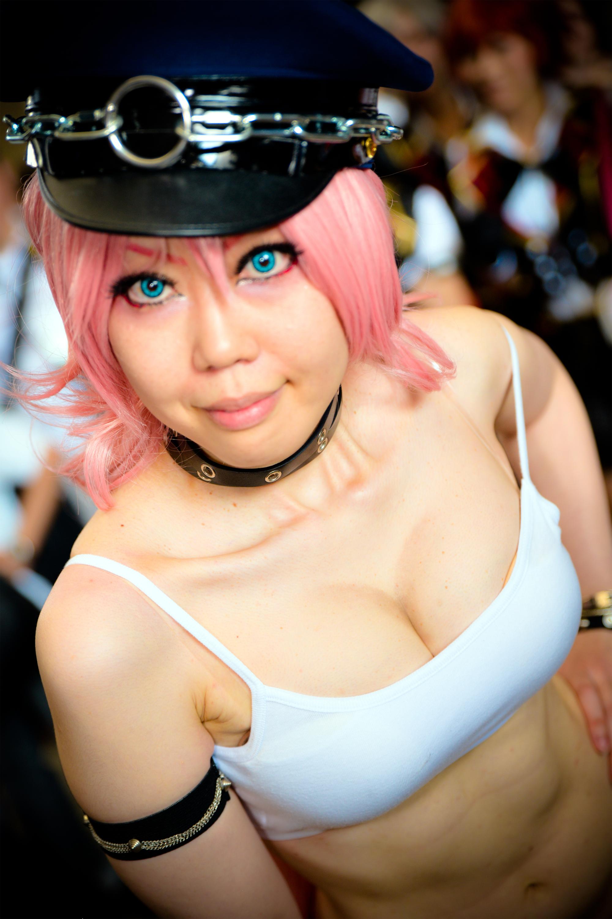 armband blue_eyes breasts camisole chains choker cleavage collat cosplay crop_top final_fight hand_on_hip hat midriff navel people photo pink_hair poison_(final_fight) police_hat real real_person smile