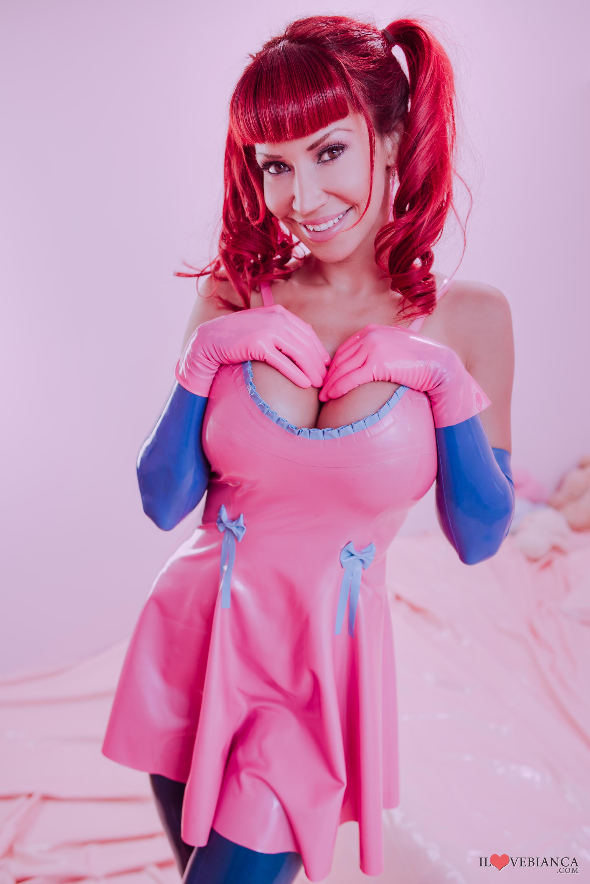 bianca_beauchamp breasts dress female high_heels large_breasts latex long_hair red_hair shoes simple_background solo thighhighs watermark