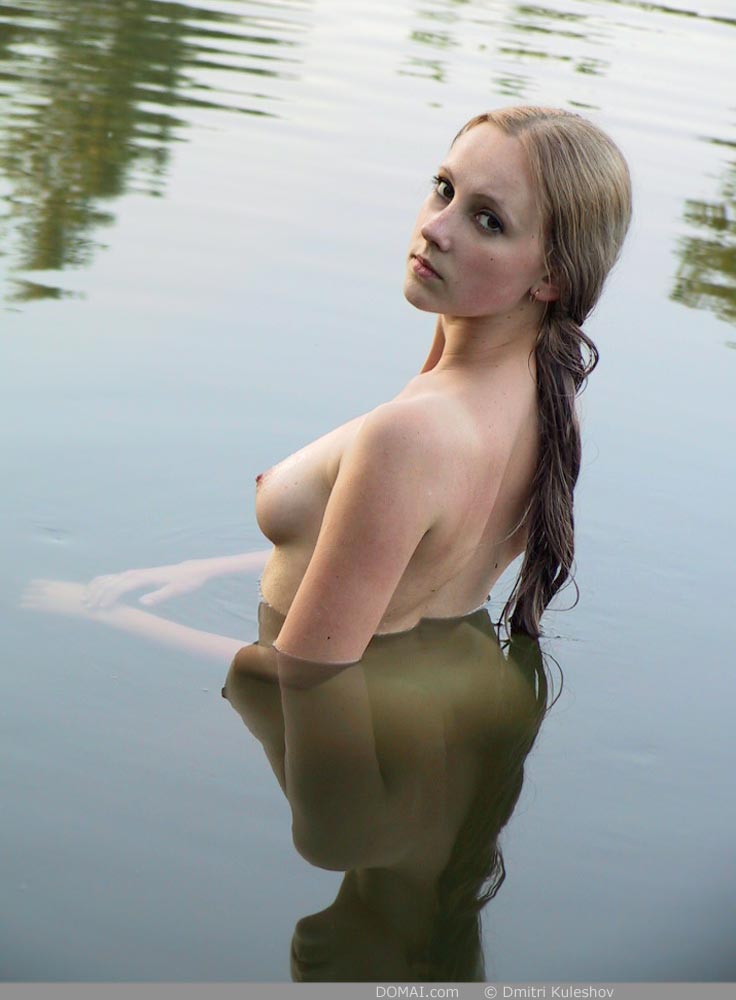 alena(domai) backside blonde_hair brown_eyes in_water lake long_hair looking_back nude outside over_the_shoulder slender wet