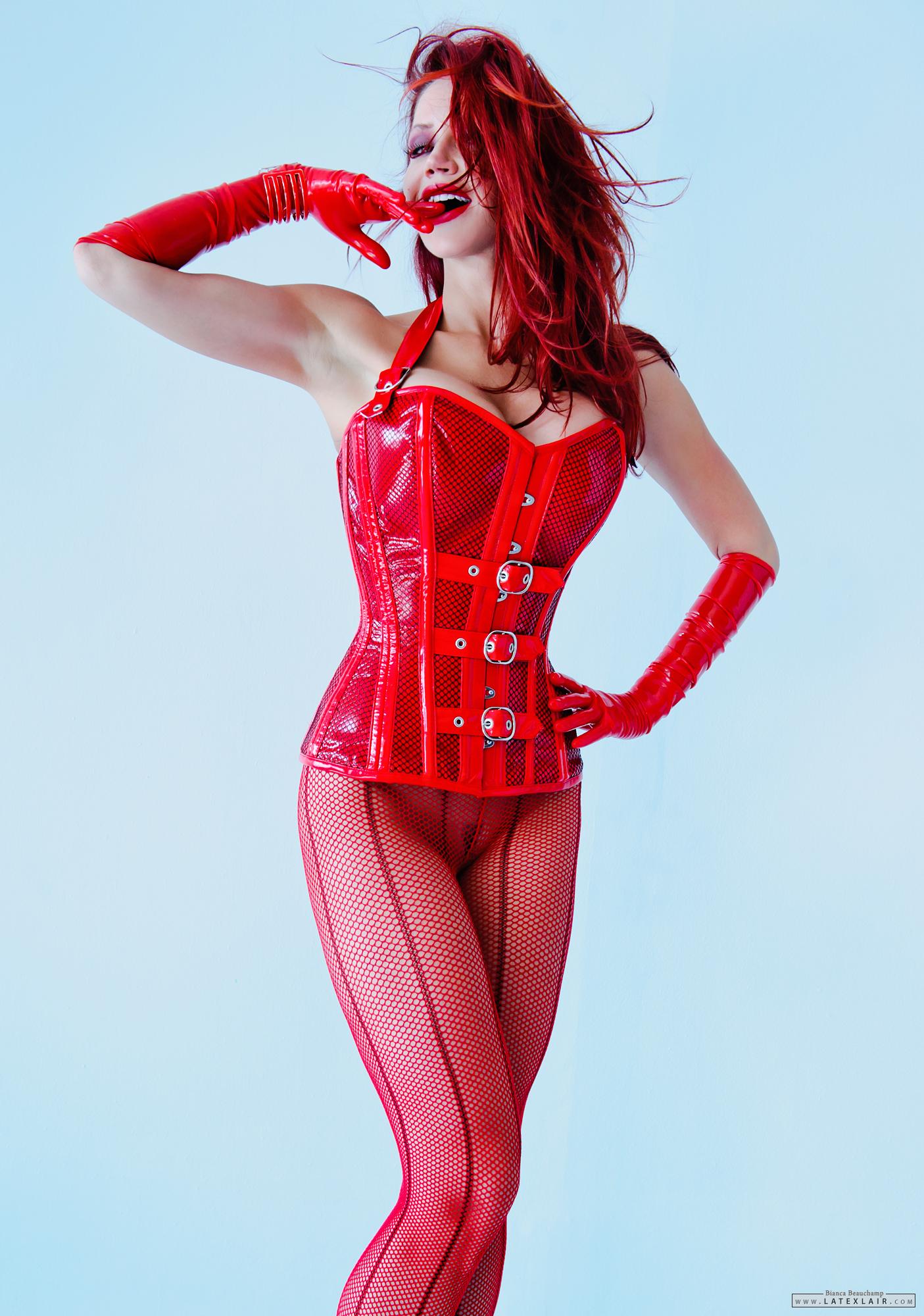 bianca_beauchamp breasts cleavage corset female fishnets gloves high_heels large_breasts latex lipstick long_hair makeup red_hair shoes simple_background solo watermark