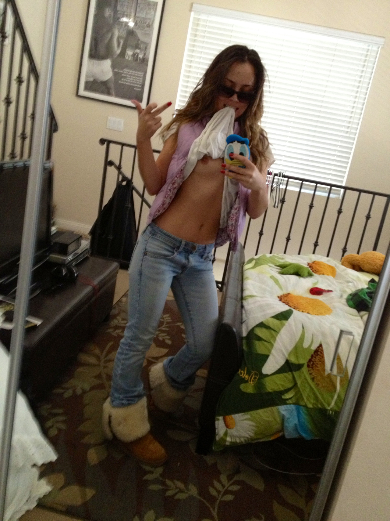 1girl bedroom cellphone female indoors jeans long_hair mirror mirror_selfie navel nipples selfie shirt_in_mouth shirt_lift small_breasts solo stomach tagme