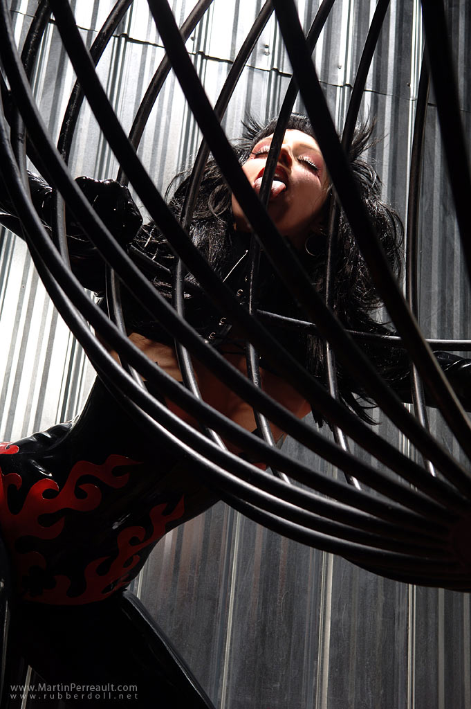 black_hair breasts cage female large_breasts latex long_hair rubberdoll solo watermark
