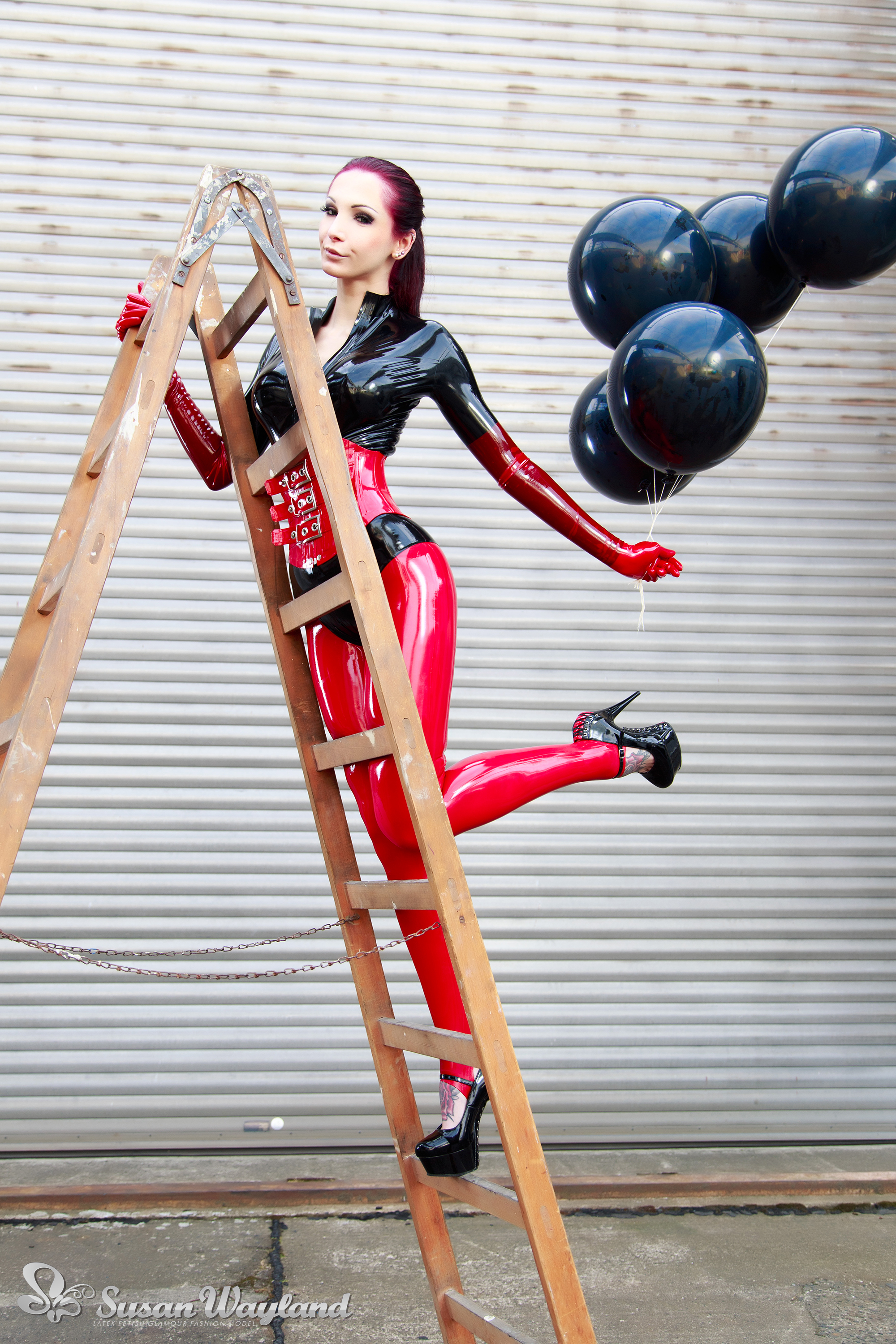 balloon black_hair breasts catsuit corset female gloves high_heels ladder large_breasts latex long_hair shoes solo susan_wayland watermark