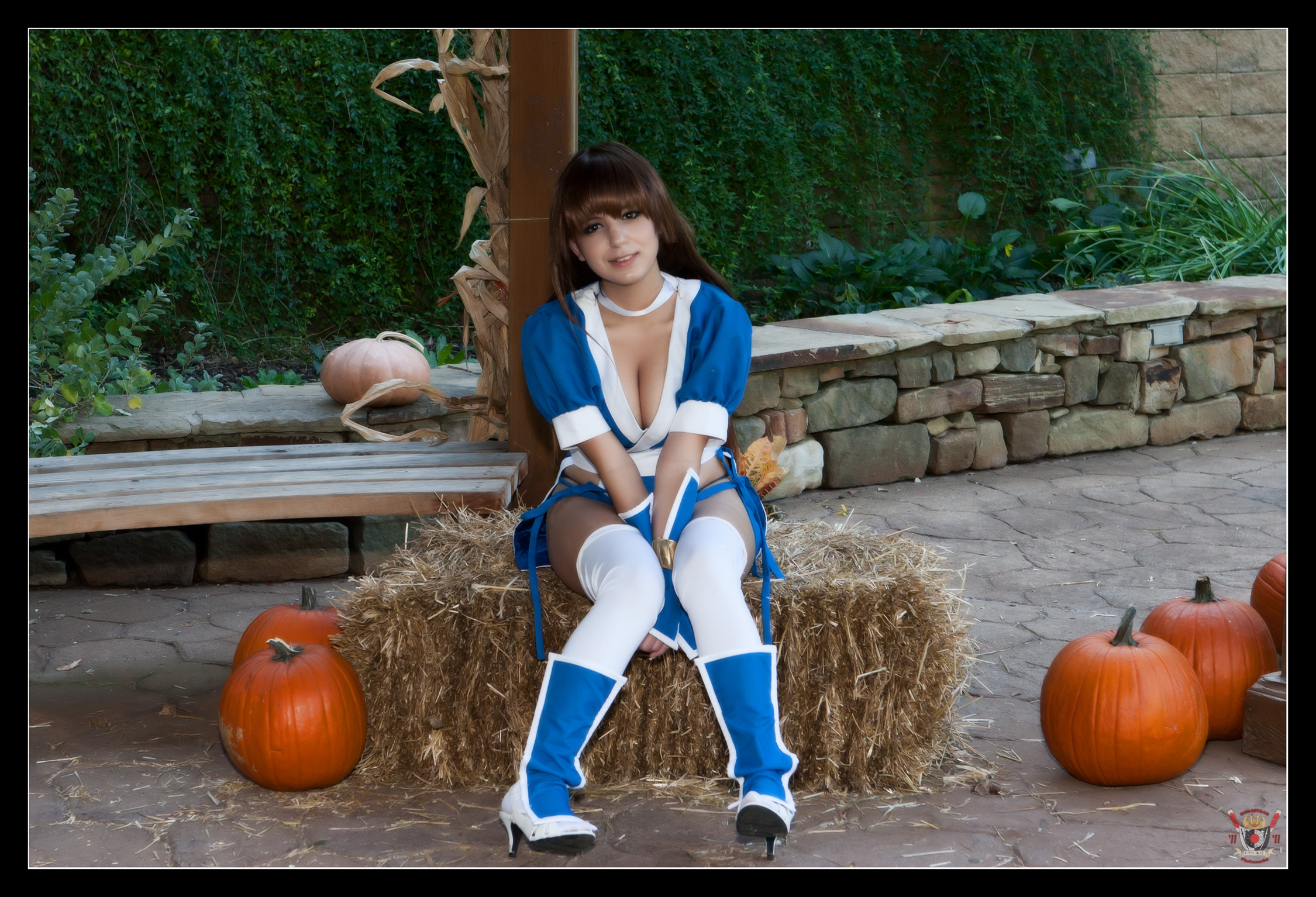 boots breasts brown_hair bunny_ayumi cleavage cosplay female high_heels large_breasts long_hair outside pumpkin sitting solo