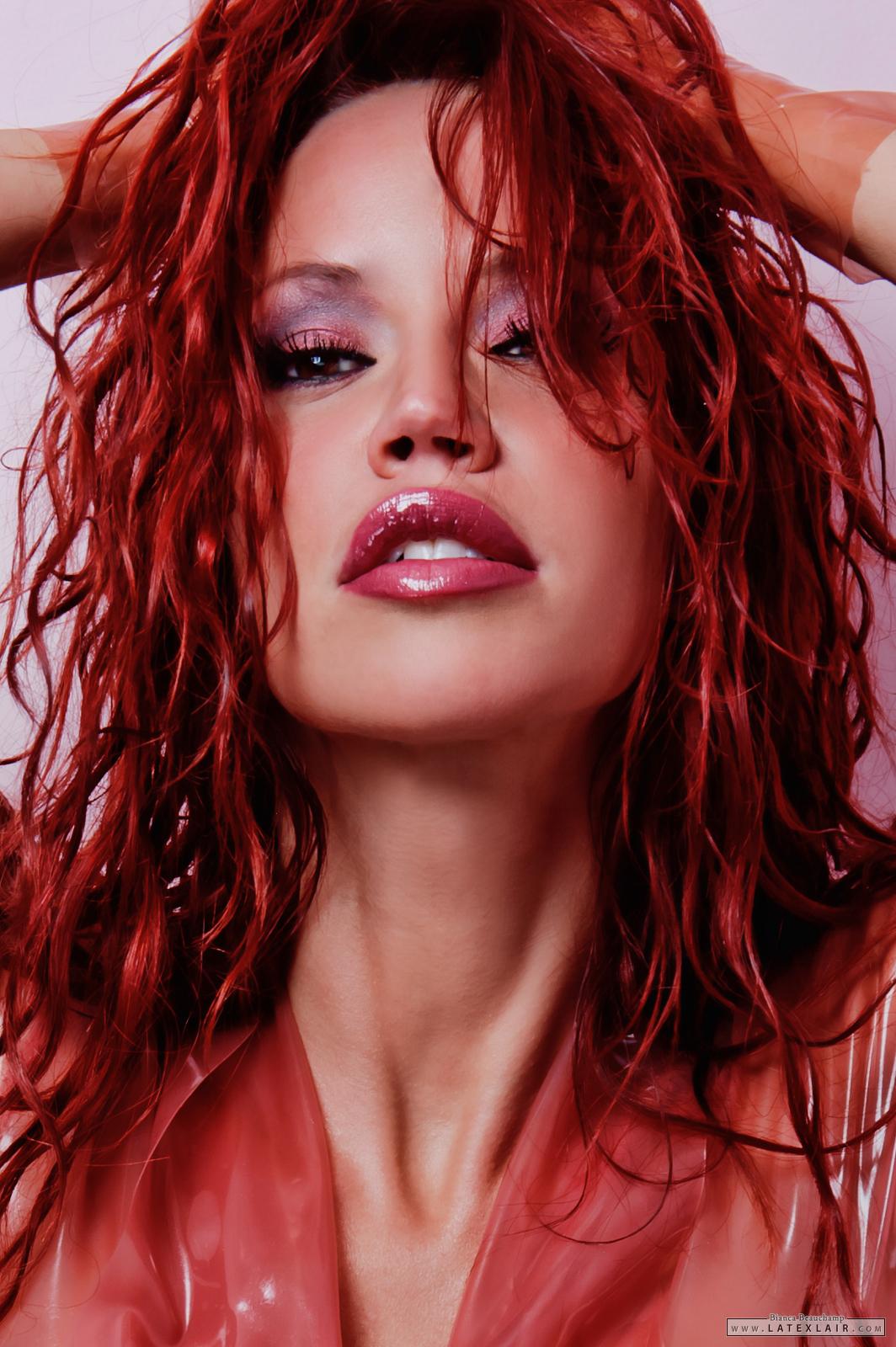 belt bianca_beauchamp breasts female large_breasts latex lipstick long_hair red_hair see-through simple_background solo watermark