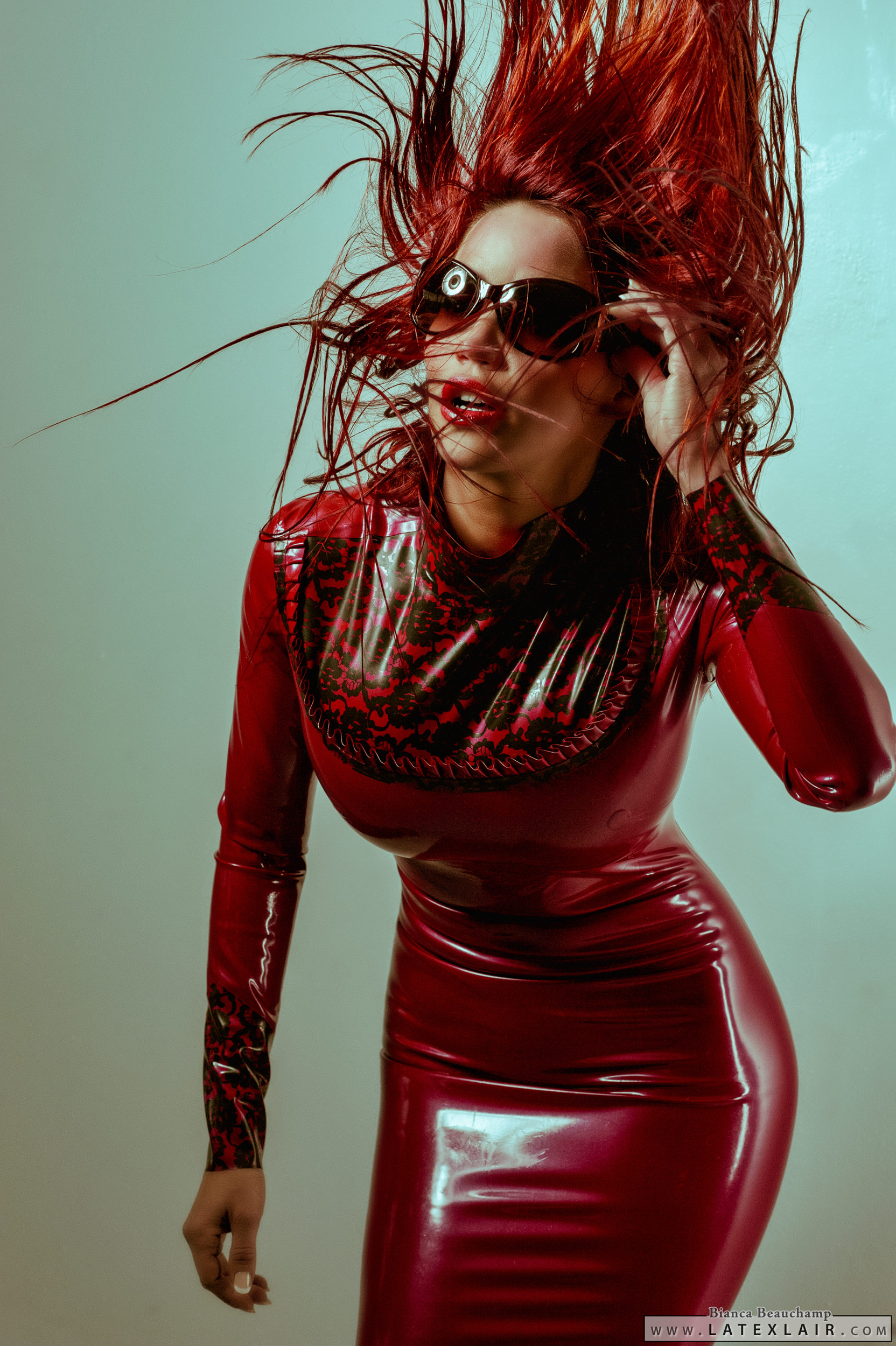 bianca_beauchamp breasts dress female large_breasts latex lipstick long_hair red_hair simple_background solo sunglasses watermark