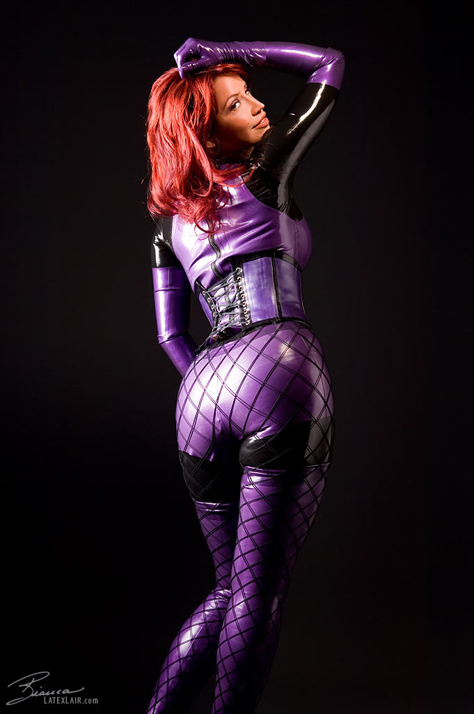 ass bianca_beauchamp breasts catsuit female gloves large_breasts latex long_hair looking_back red_hair simple_background solo watermark