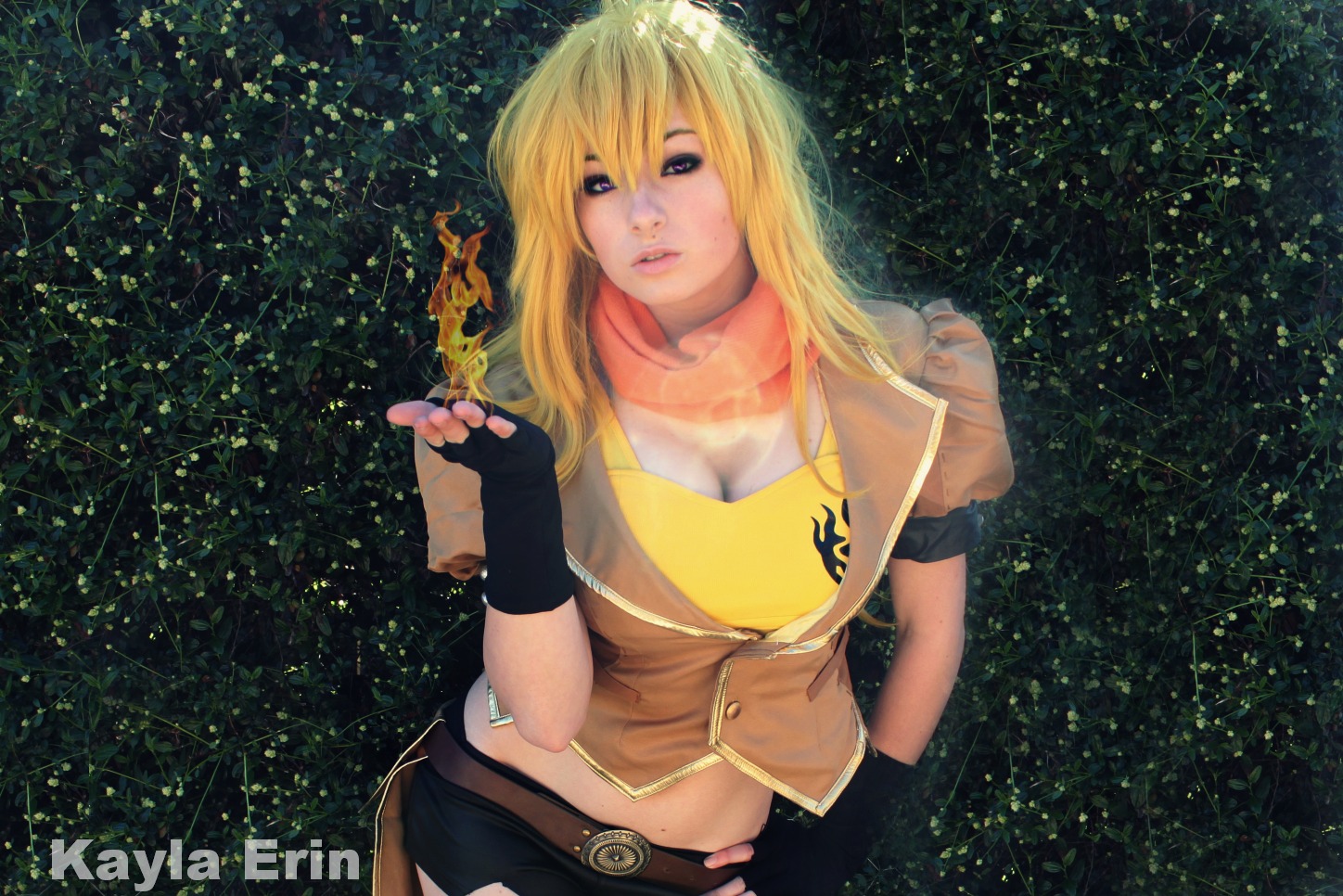 1girl blonde_hair breasts cleavage cosplay female hotpants kayla_erin large_breasts long_hair midriff navel outside rwby shorts solo yang_xiao_long