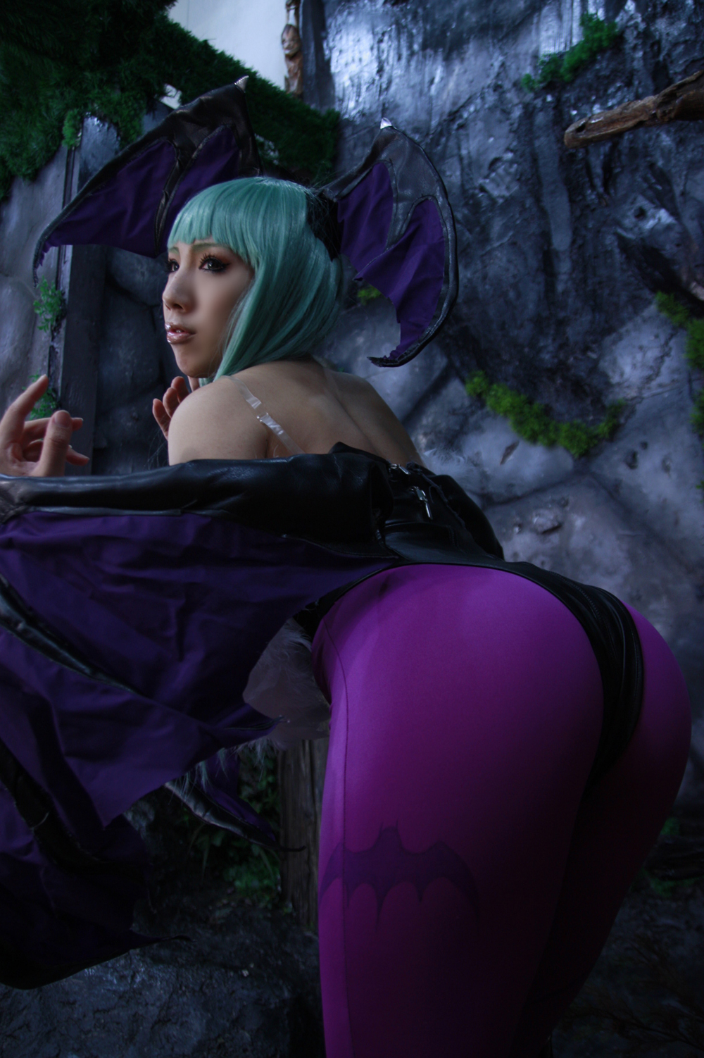 asian ass bare_shoulders breasts cleavage cosplay female green_hair large_breasts leotard long_hair looking_back nonsummerjack solo wings