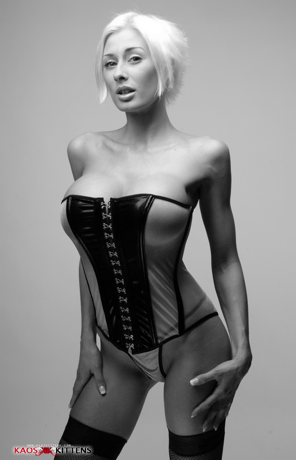 bare_shoulders blonde_hair breasts cleavage corset female large_breasts marie-claude_bourbonnais monochrome short_hair solo watermark