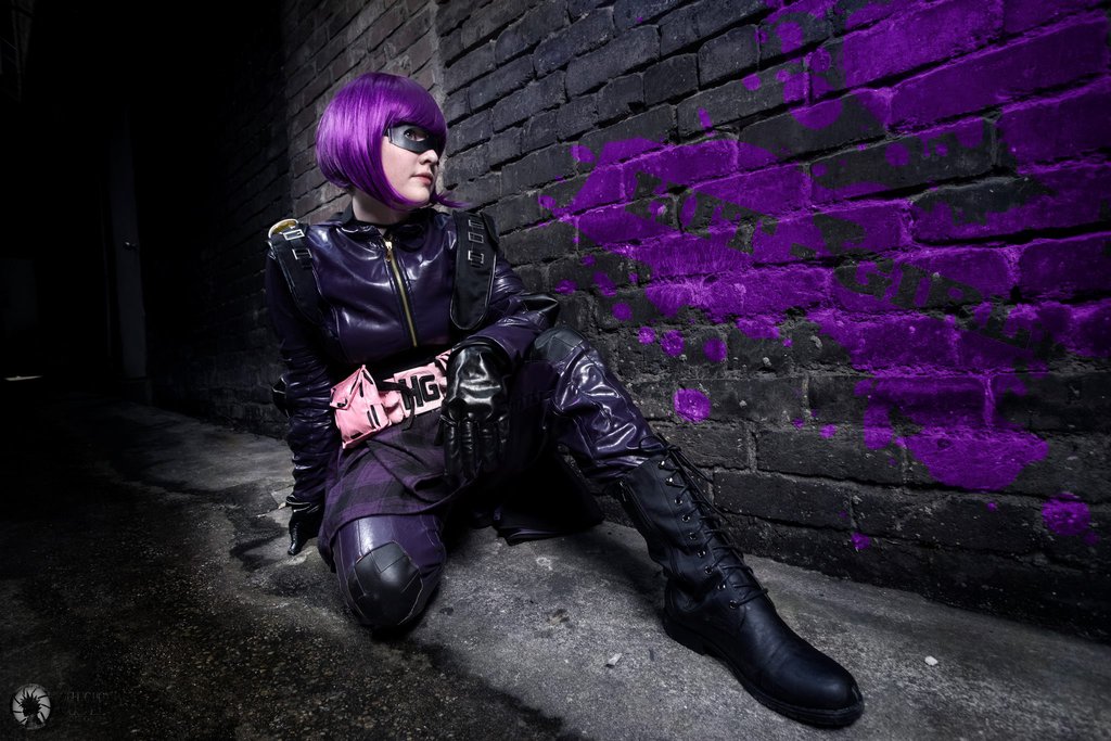 1girl alley breasts cosplay female foxycosplay hit-girl kick-ass long_hair outside purple_hair solo tagme