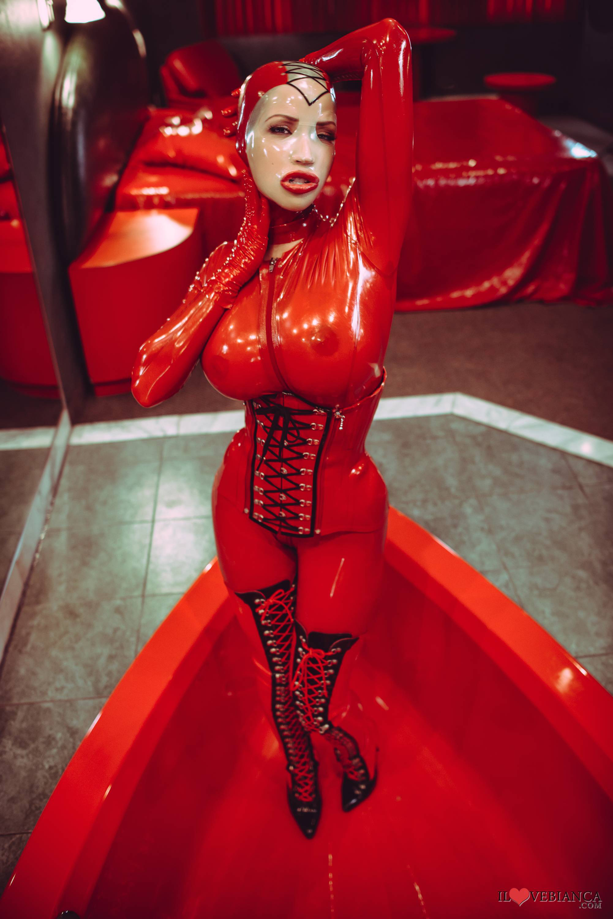 bianca_beauchamp breasts catsuit corset female large_breasts latex long_hair mask red_hair solo watermark