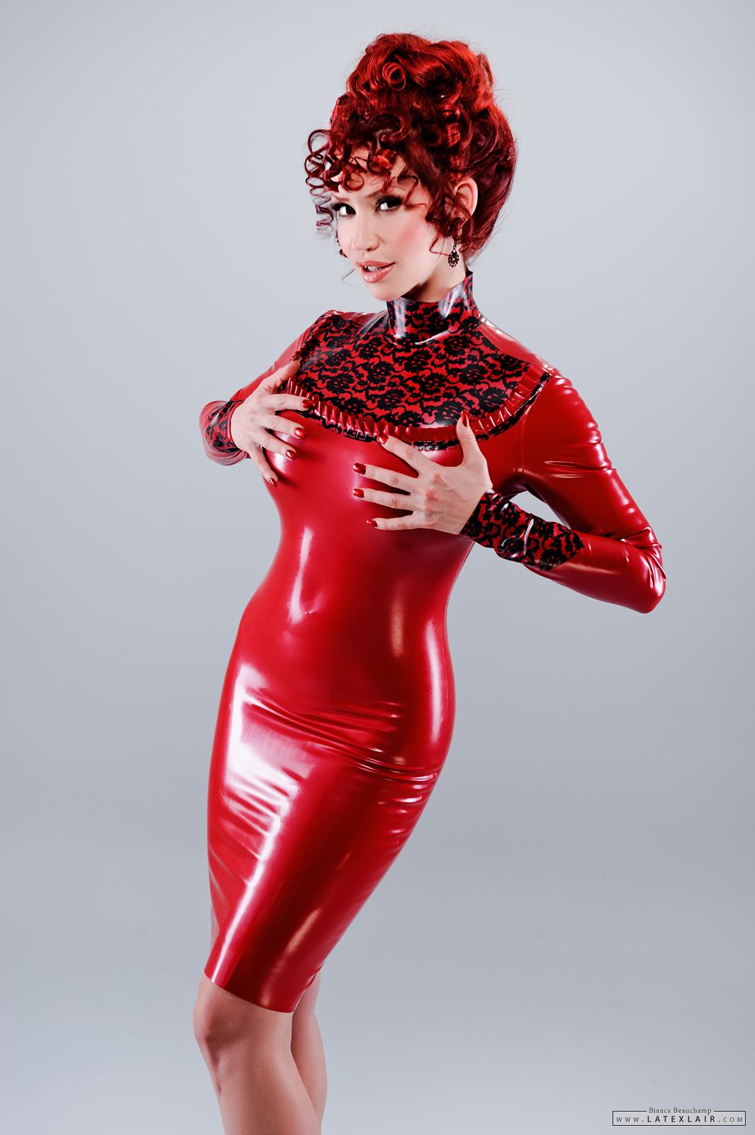 bianca_beauchamp breasts dress female high_heels large_breasts latex long_hair nail_polish red_hair shoes simple_background solo watermark