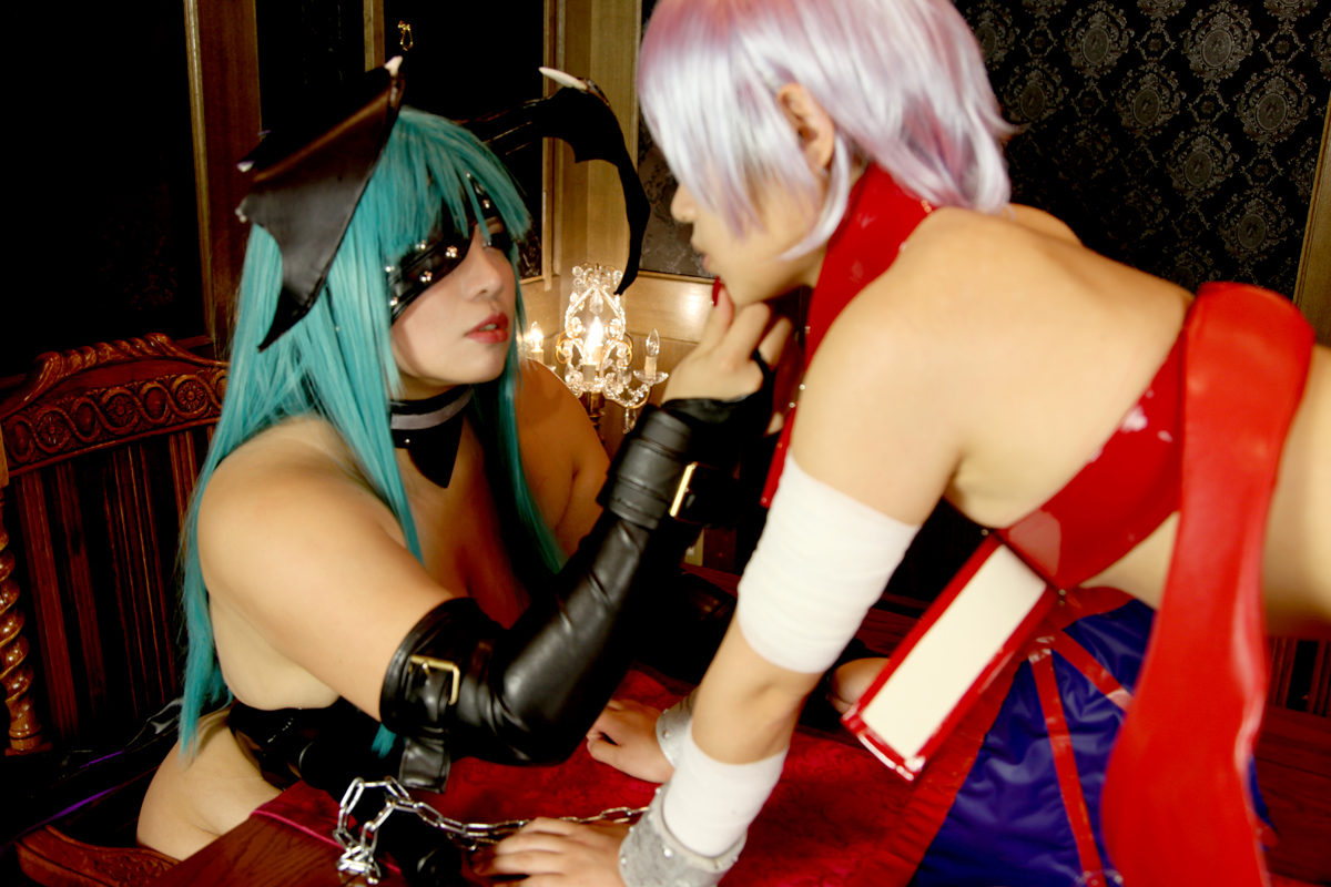 2girls aqua_hair bare_shoulders breasts capcom choker chouzuki_maryou cleavage cosplay darkstalkers female female_only huge_breasts lilith_aensland long_hair morrigan_aensland non-nude partially_clothed plump solo succubus suzuka_itsuki watermark wings