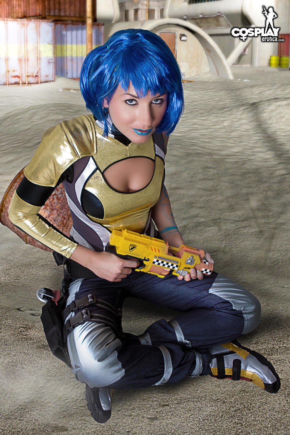 1girl blue_hair boots borderlands borderlands_2 breasts brown_eyes cleavage clothed clothed_female cosplay cosplayerotica female female_only gun lipstick looking_at_viewer makeup maya maya_(cosplay) outdoors outside pants shiny shirt shoes short_hair siren solo sparkly tattoo weapon wig