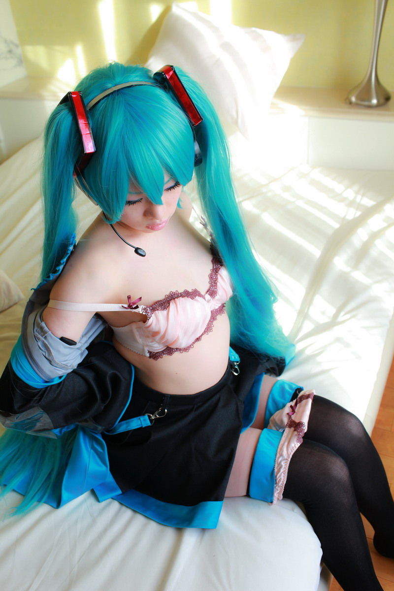 aqua_hair arai_yomi bed blouse bra cleavage cosplay detached_sleeves headset miku_hatsune open_clothes photo pleated_skirt real real_person skirt tie twin_tails vocaloid