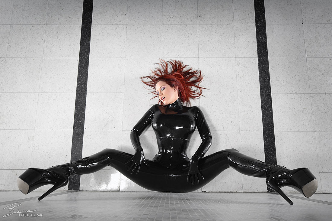 bianca_beauchamp breasts catsuit female gloves high_heels large_breasts latex long_hair red_hair shoes solo watermark