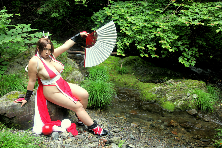 asian breasts brown_eyes brown_hair chouzuki_maryou cosplay fan female female_only hair_ornament hanging_breasts king_of_fighters large_breasts leaning_forward long_hair mai_shiranui mai_shiranui_(cosplay) plump ponytail snk solo thick_thighs thighs tied_hair very_long_hair