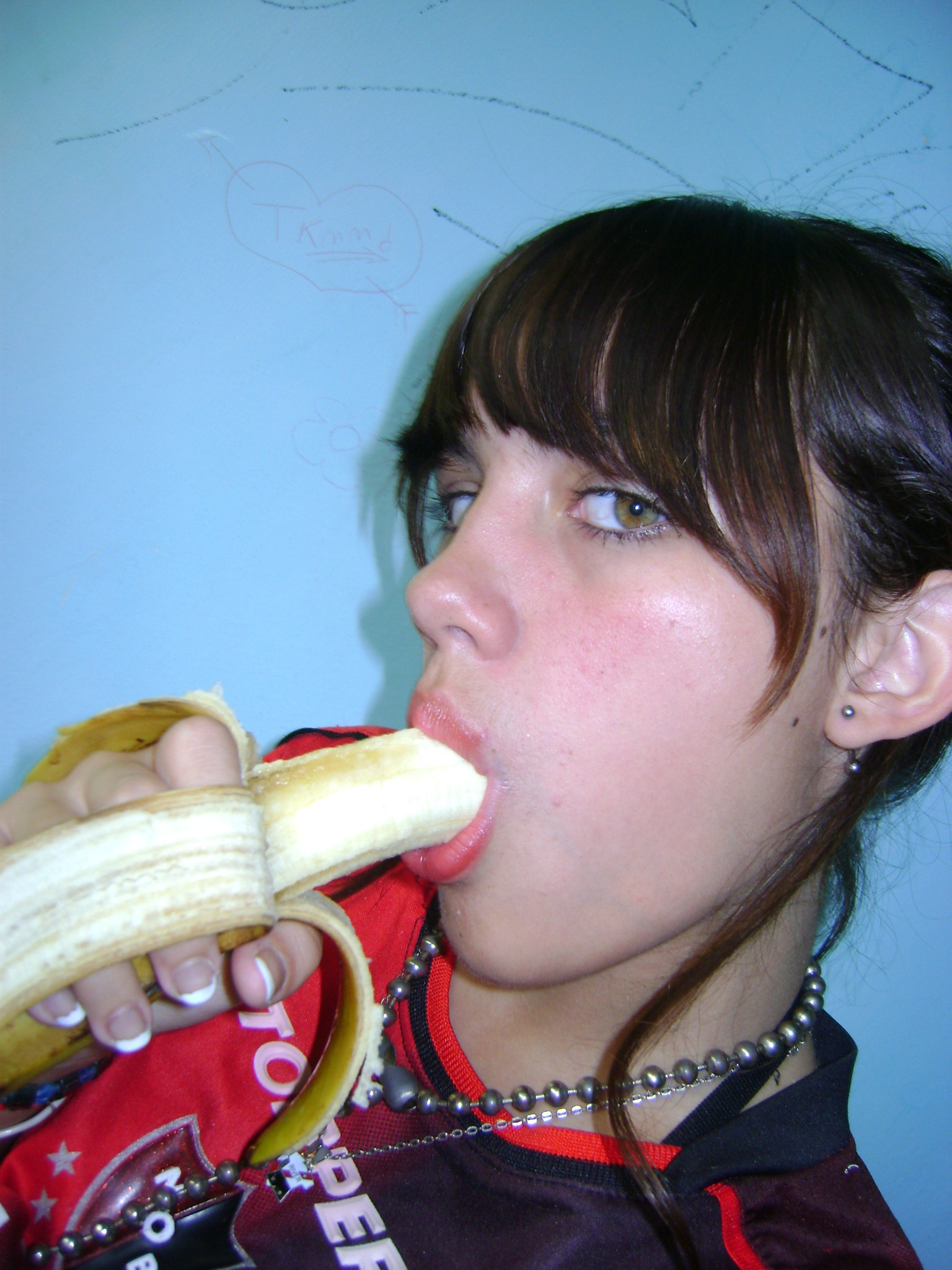 1girl banana banana_in_mouth brunette female female_focus female_only looking_at_the_viewer looking_at_viewer model_request phallic photo real_person selfie simple_background solo solo_female solo_focus source_request suck sucking suggestive suggestive_food