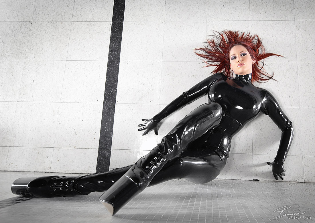 bianca_beauchamp breasts catsuit female gloves high_heels large_breasts latex long_hair red_hair shoes solo watermark