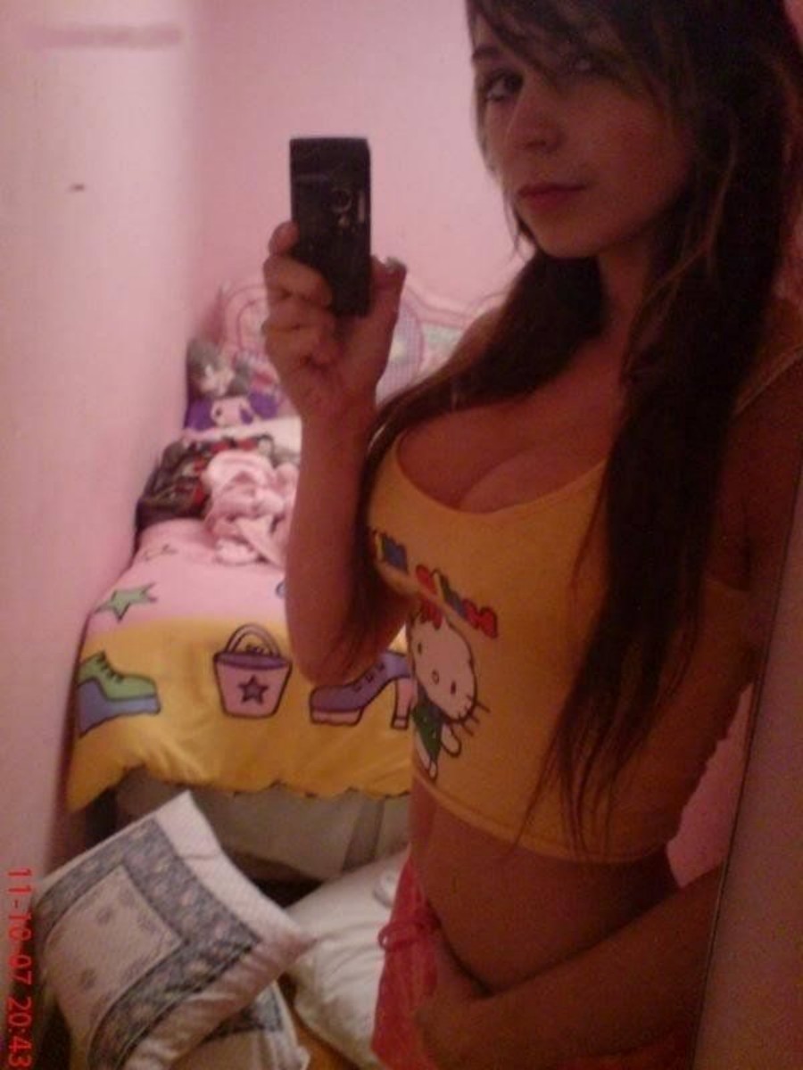 1girl bedroom breasts brown_hair cleavage crop_top female female_only hello_kitty indoors long_hair medium_breasts mirror mirror_selfie selfie solo tagme