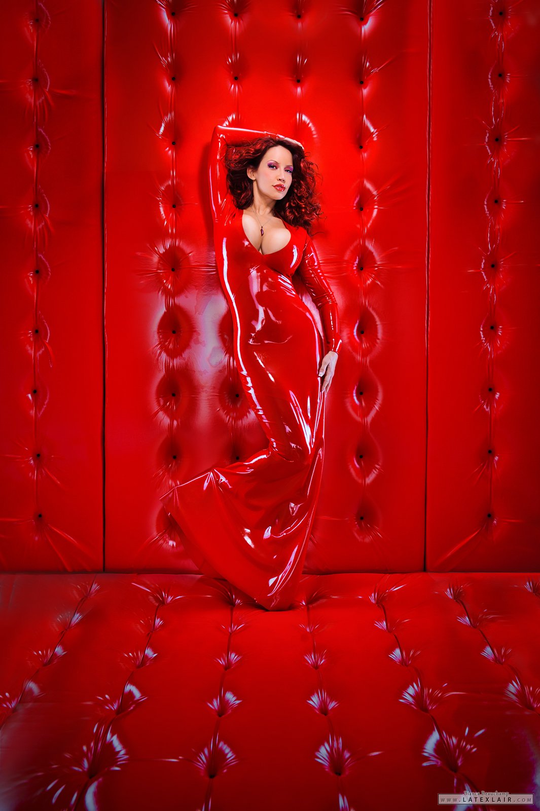 bianca_beauchamp breasts cleavage dress female large_breasts latex long_hair makeup necklace red_hair solo watermark