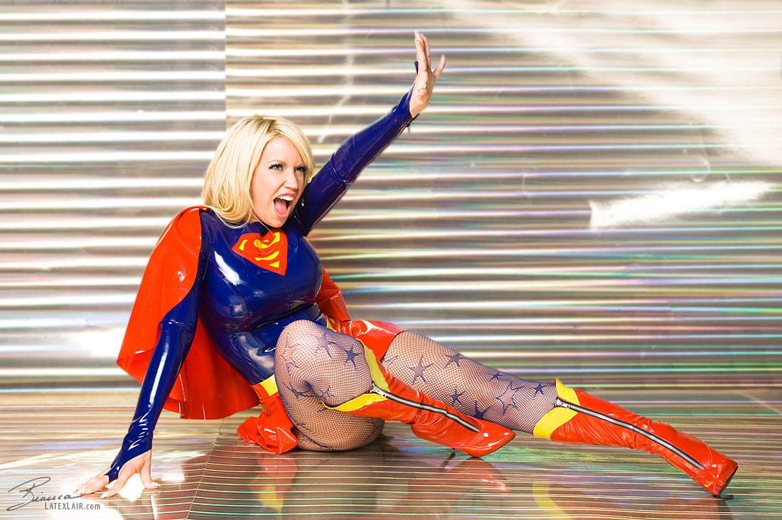 1girl bianca_beauchamp blonde_hair breasts clothed cosplay dc female female_only high_heel_boots large_breasts latex long_hair non-nude open_mouth pantyhose solo supergirl tan_skin watermark