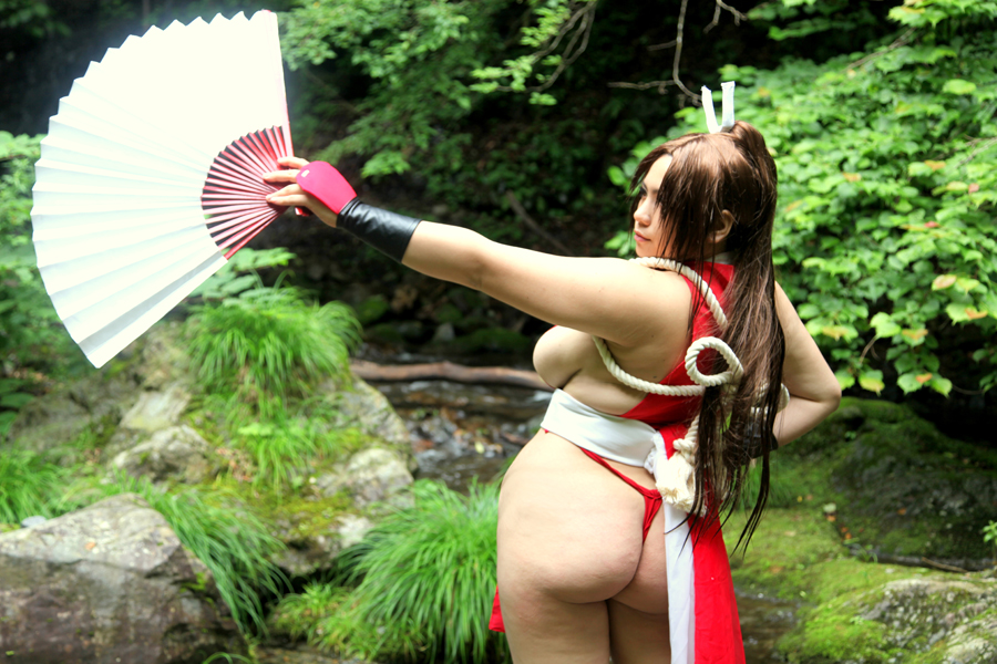 asian ass backboob breasts brown_eyes brown_hair chouzuki_maryou cosplay fan female female_only hair_ornament huge_ass king_of_fighters large_breasts long_hair mai_shiranui mai_shiranui_(cosplay) plump ponytail solo thick_thighs thighs tied_hair very_long_hair