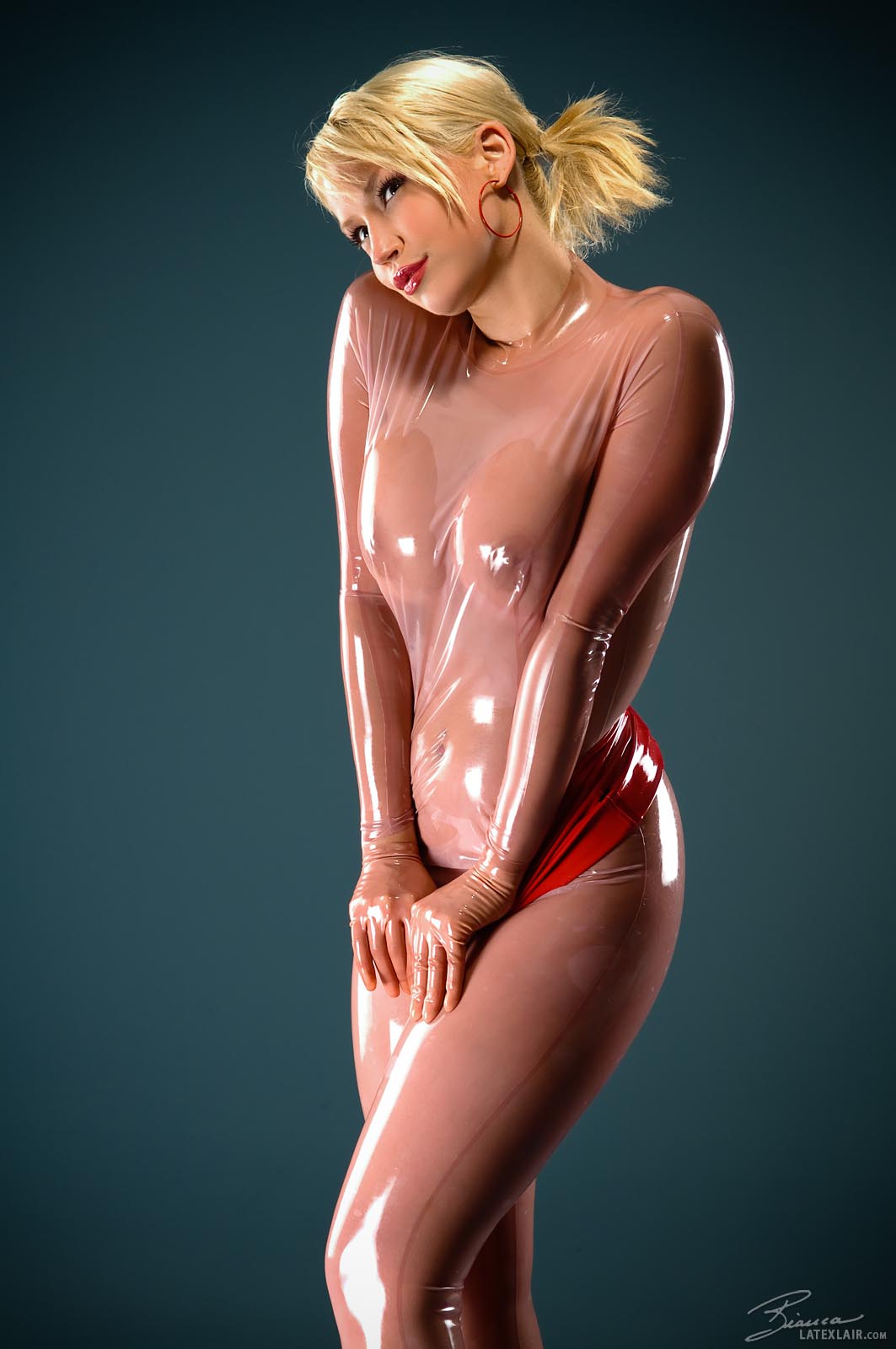bianca_beauchamp blonde_hair breasts catsuit dress female high_heels large_breasts latex long_hair see-through shoes simple_background watermark