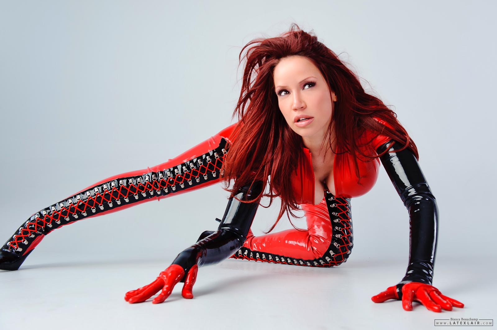 bianca_beauchamp boots breasts cleavage corset female gloves high_heels large_breasts latex long_hair red_hair simple_background solo watermark