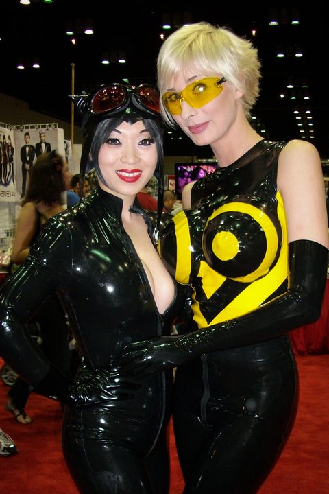 2girls asian big_breasts blonde_hair breasts catwoman cosplay dc female female_only large_breasts marie-claude_bourbonnais photo short_hair solo watermark yaya_han