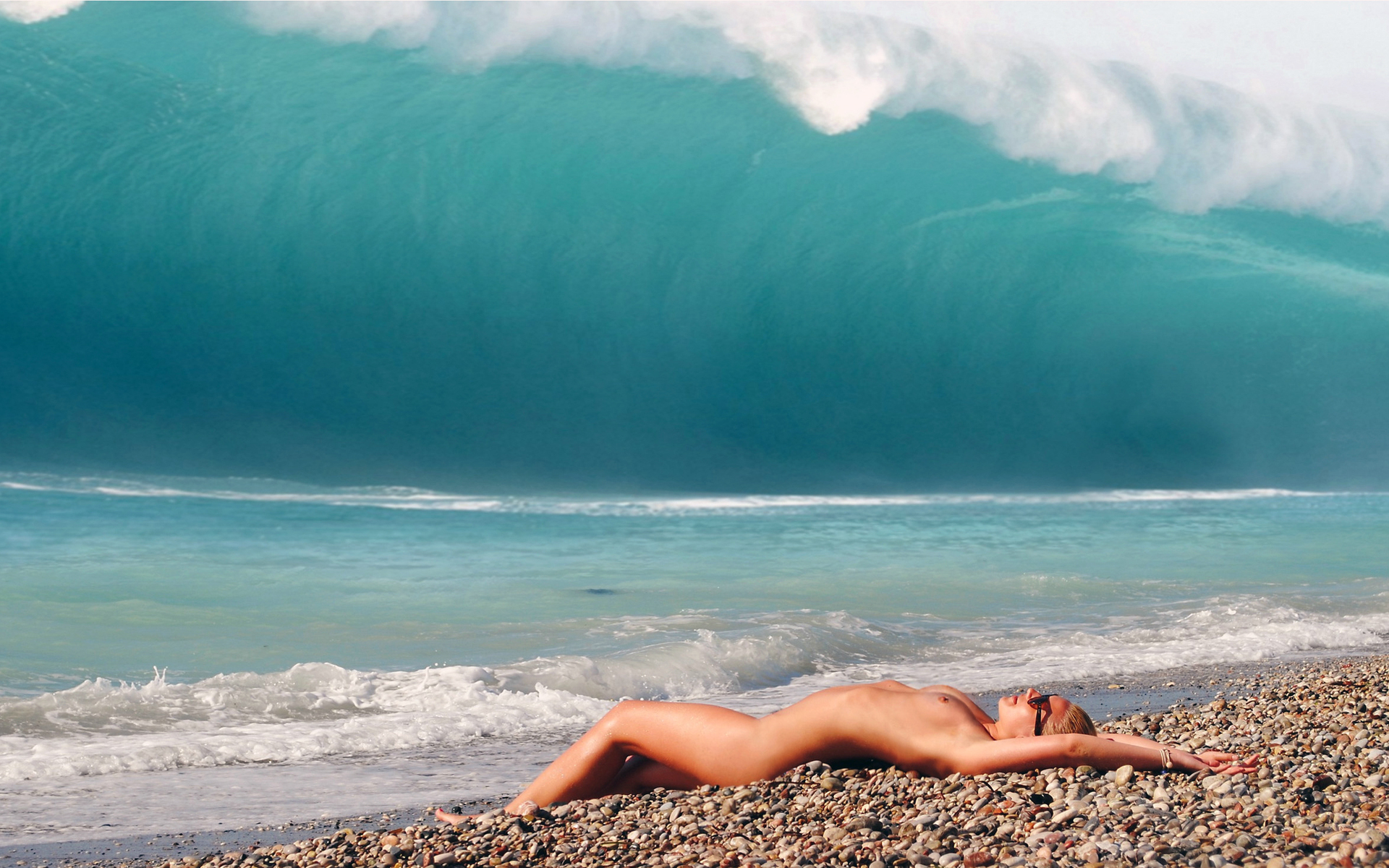 beach brown_hair lying nude on_back outside slender small_breasts sunglasses