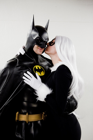 1_boy 1_girl 1boy 1female 1girl 1male 2_humans 2humans 5_fingers batman batman_(series) belt black_cat bodysuit bruce_wayne cape caucasian clothed clothed_female clothed_male clothes clothing cosplay costume crossover dc dc_comics domino_mask felicia_hardy fur_trim gloves hair human human_only kiss kissing leaning_forward long_hair looking_at_viewer marvel marvel_comics mask non-nude not_furry outfit photo real real_person smirk spider-man_(series) standing superhero superheroine uncensored utility_belt white_background white_gloves white_hair