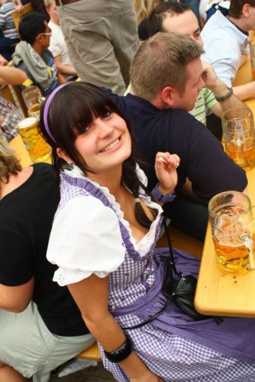 alcohol bavaria beer black_hair breasts cleavage dirndl dress female german germany long_hair oktoberfest sitting smile solo_focus thechive.com/2012/09/25/oktoberfest-is-upon-us-once-again-let-the-cleavage-flow-like-beer-45-photos