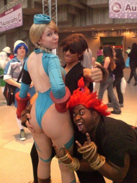 2boys 5girls \m/ ass ass_grab bangs big_ass blonde_hair cammy_white cammy_white_(cosplay) capcom con_photo cosplay gouki gouki_(cosplay) hand_on_hip huge_ass ikuy leotard long_hair looking_at_viewer looking_back multiple_boys multiple_girls no_bra open_mouth pantyhose photo real real_person sakuracon street_fighter thong_leotard twin_braids