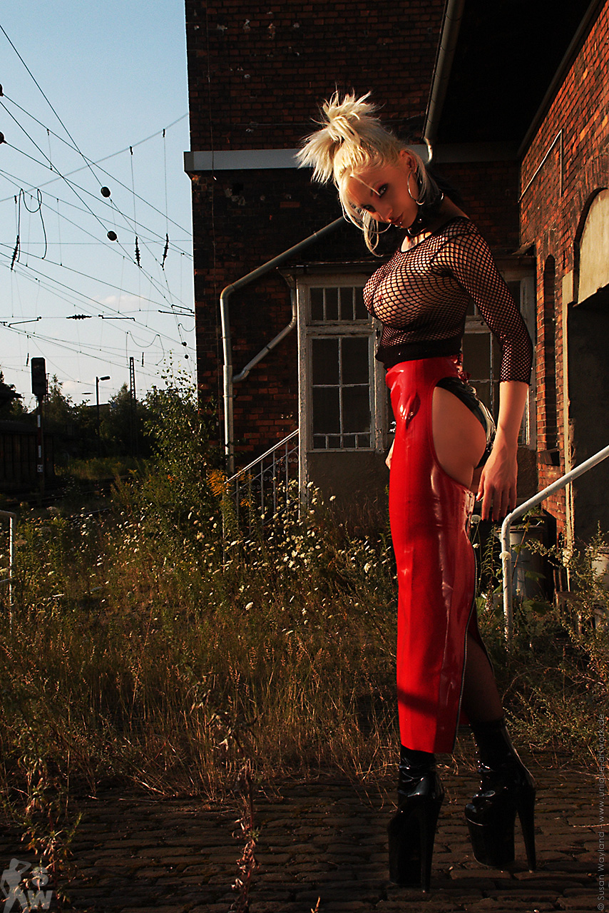 blonde_hair breasts female large_breasts latex long_hair solo susan_wayland watermark