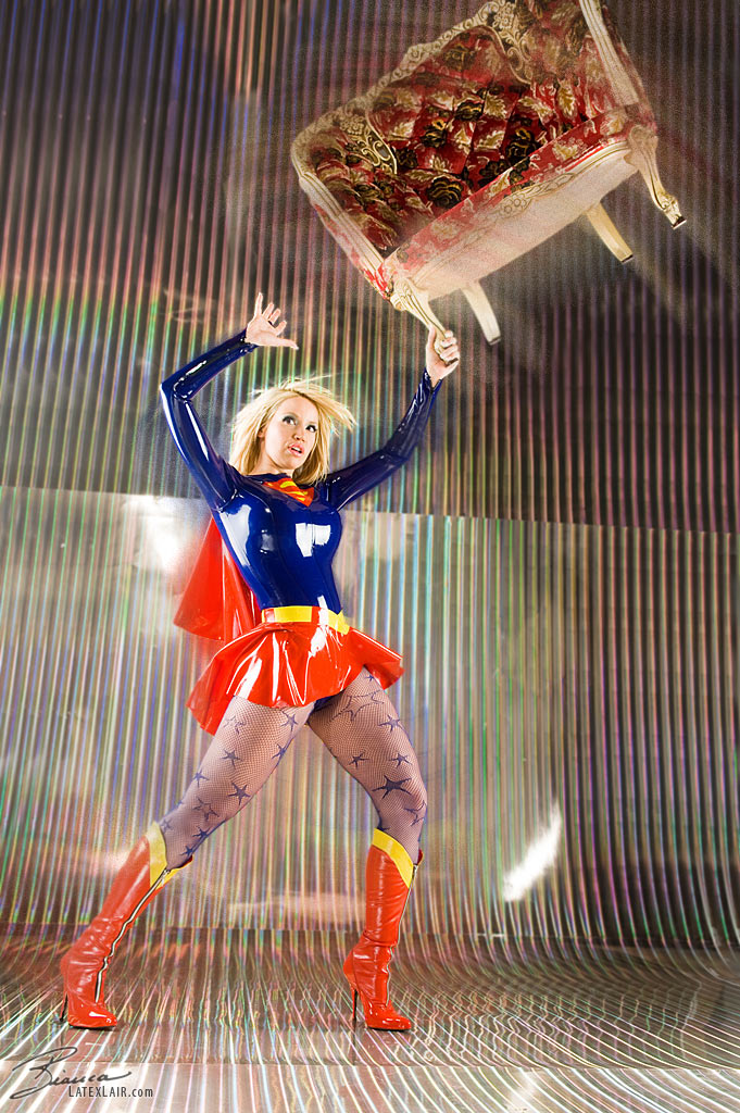 1girl bianca_beauchamp blonde_hair breasts clothed cosplay dc female female_only high_heel_boots large_breasts long_hair looking_away non_nude pantyhose parted_lips solo supergirl tan_skin watermark