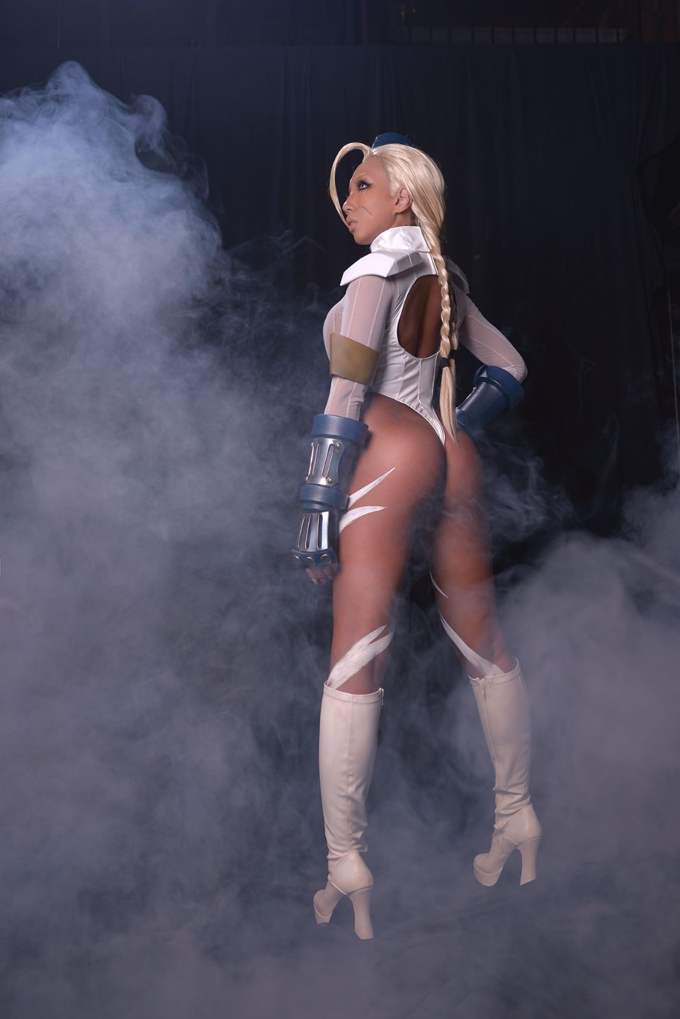 1girl asian blonde_hair body_paint boots breasts cammy_white clothed cosplay dark_hair fake_nails female female_only gloves hat high_heels knee_boots leotard long_hair non-nude nonsummerjack solo street_fighter thong thong_leotard
