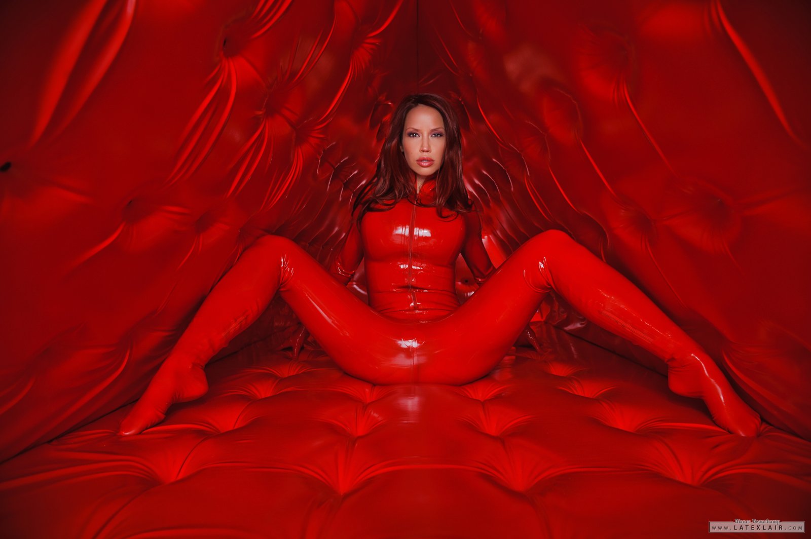 bianca_beauchamp breasts catsuit female gloves high_heels large_breasts latex long_hair red_hair shoes simple_background solo watermark