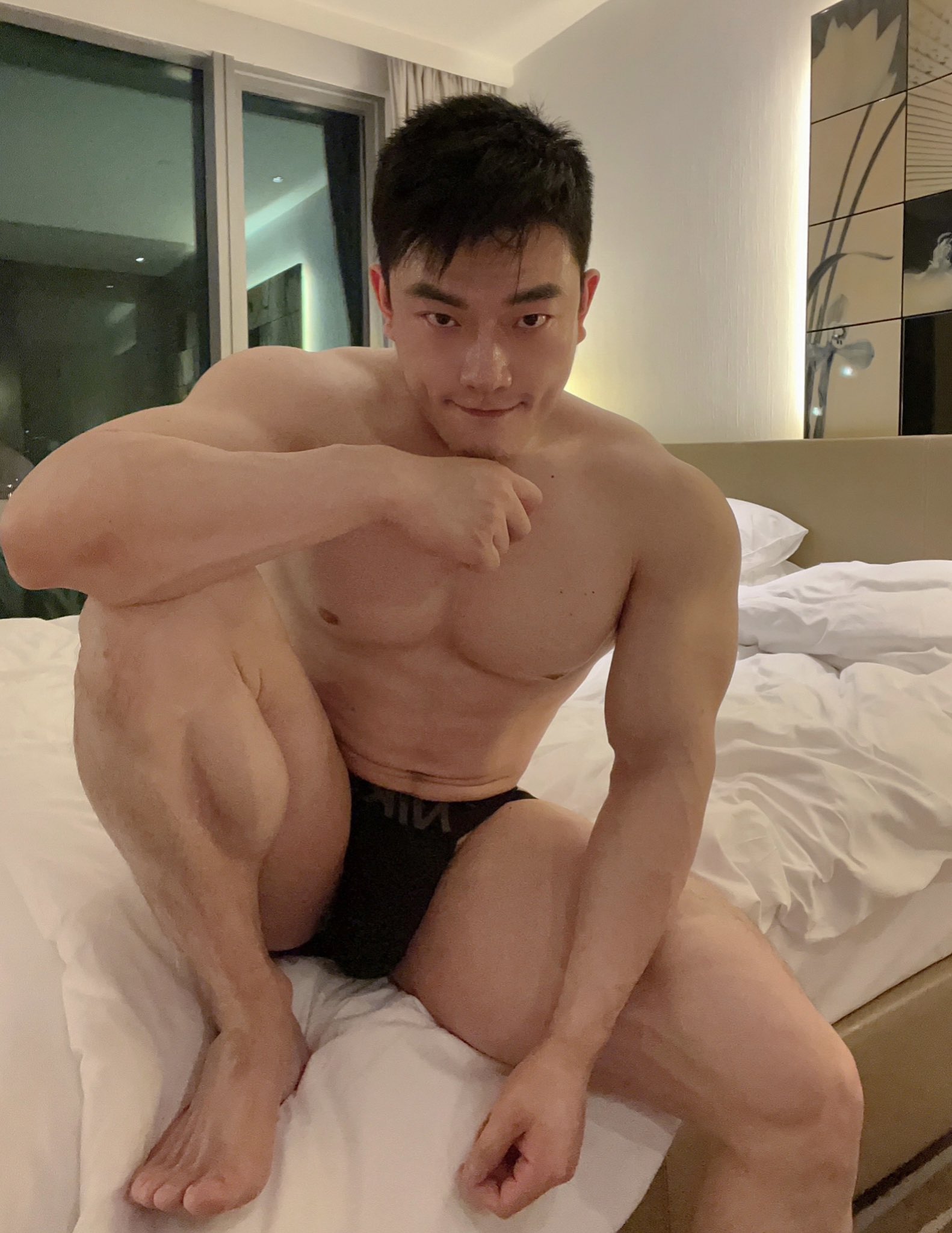 1boy asian asian_male barefoot bed bulge captainyangpu feet gay light-skinned_male light_skin looking_at_viewer male male_focus male_only masculine muscular_male non-nude on_bed solo solo_male sourced twitter vertical_image