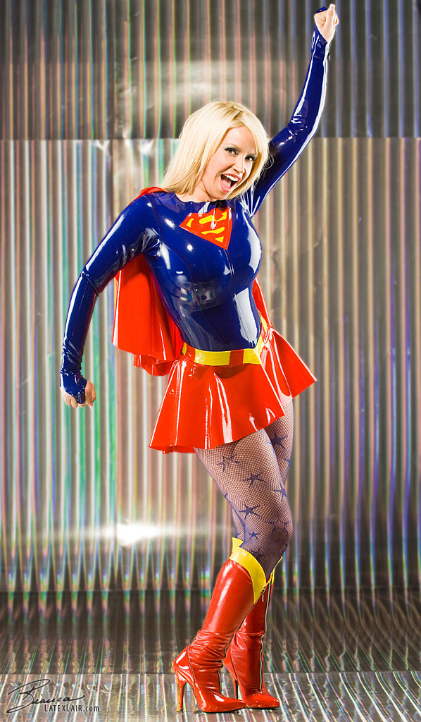 1girl bianca_beauchamp blonde_hair breasts clothed cosplay dc female female_only high_heel_boots large_breasts latex long_hair looking_away non-nude open_mouth pantyhose solo supergirl tan_skin watermark