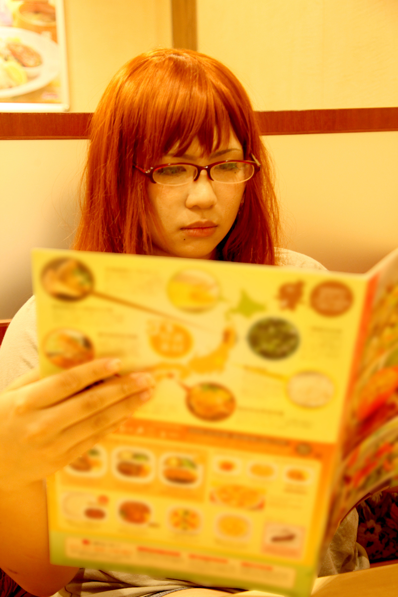 breasts brown_hair chouzuki_maryou female food glasses huge_breasts long_hair restaurant sitting solo watermark